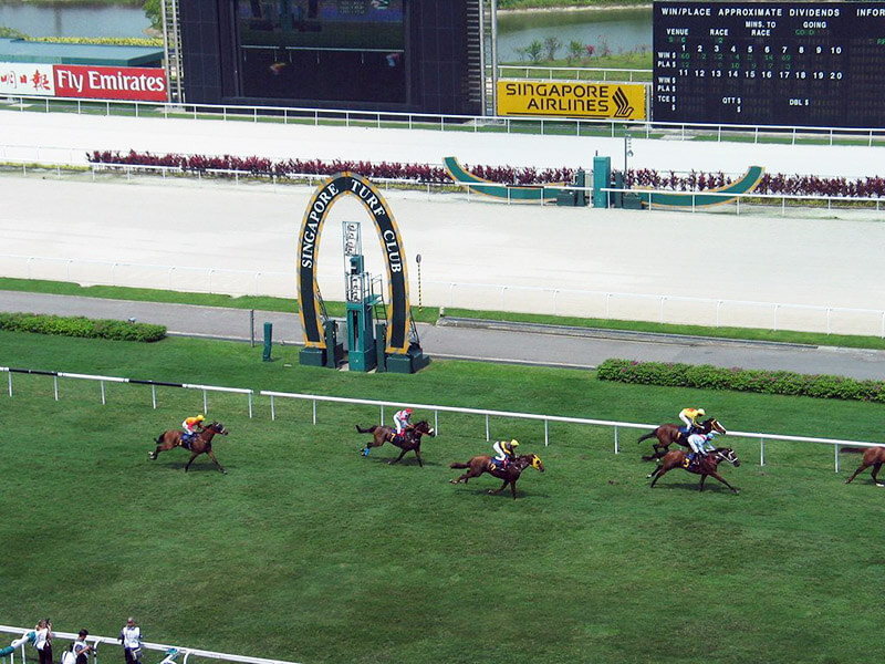 A horserace at the Singapore Turf Club. Despite the popularity of the races, betting on them is illegal and police raids recently netted almost 90 participants. (Image: Flickr)