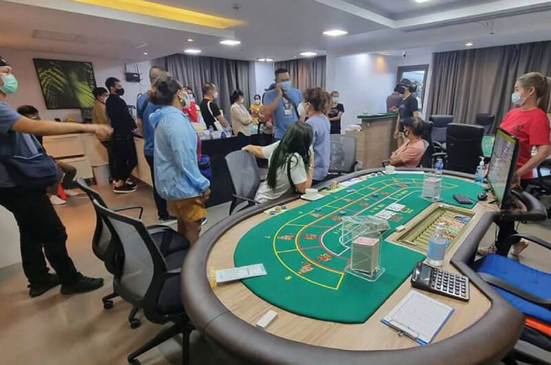 A police raid on an illegal casino in Thailand.