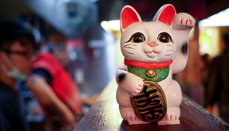 Because of its popularity in Chinese and Vietnamese communities (including Chinatowns in the United States), the maneki-neko is frequently mistaken for being Chinese in origin rather than Japanese, and is therefore sometimes referred to as a "Chinese lucky cat or jīnmāo ("golden cat"). This cat is also prevalent in China domestically, and is usually referred to as simplified Chinese: 招财猫; traditional Chinese: 招財貓; pinyin: zhāocáimāo; Jyutping: ziu1 coi4 maau1.