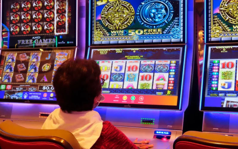 A gambler plays a slot machine at the Hard Rock casino in Atlantic City, N.J. on Aug. 8, 2022. Figures released by New Jersey gambling regulators on Tuesday, Aug. 16, 2022, show that New Jersey’s casinos, horse tracks that offer sports betting and the online partners of both types of gambling outlets won $480.7 million in July, an increase of 6.7% from a year ago.